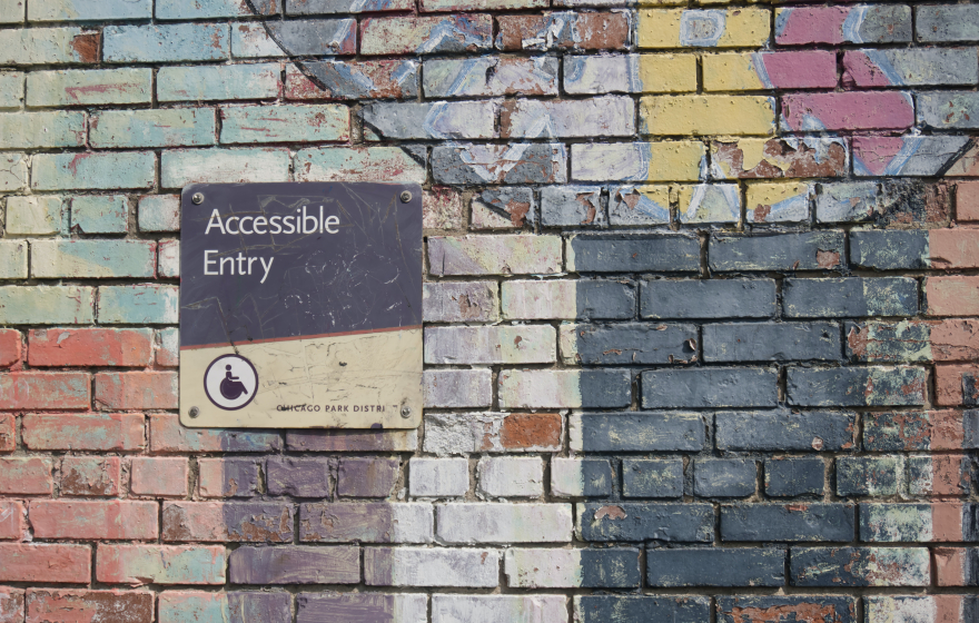 Brick background with accessible entry sign