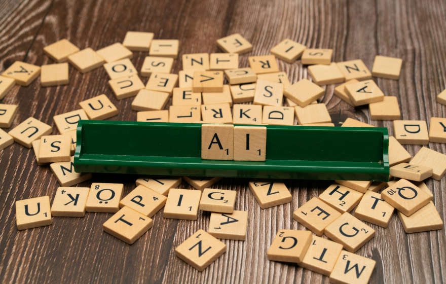 Scrabble tiles spelling out the word AI