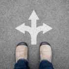 feet standing in front of three arrows pointed in different directions.