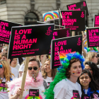 LGBTQ march people with signs saying Love is Love