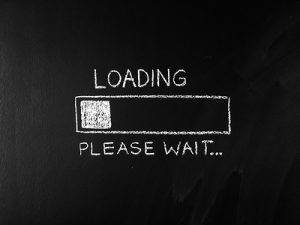 A partially filled status bar with the words: Loading, please wait written on a chalkboard.