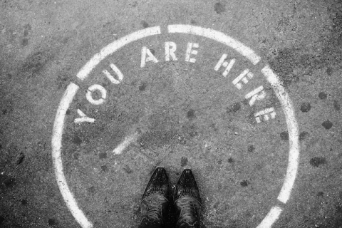 A circle on the pavement with the words "you are here